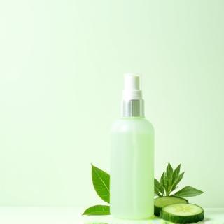 Facial toner spray bottle with plant leaves